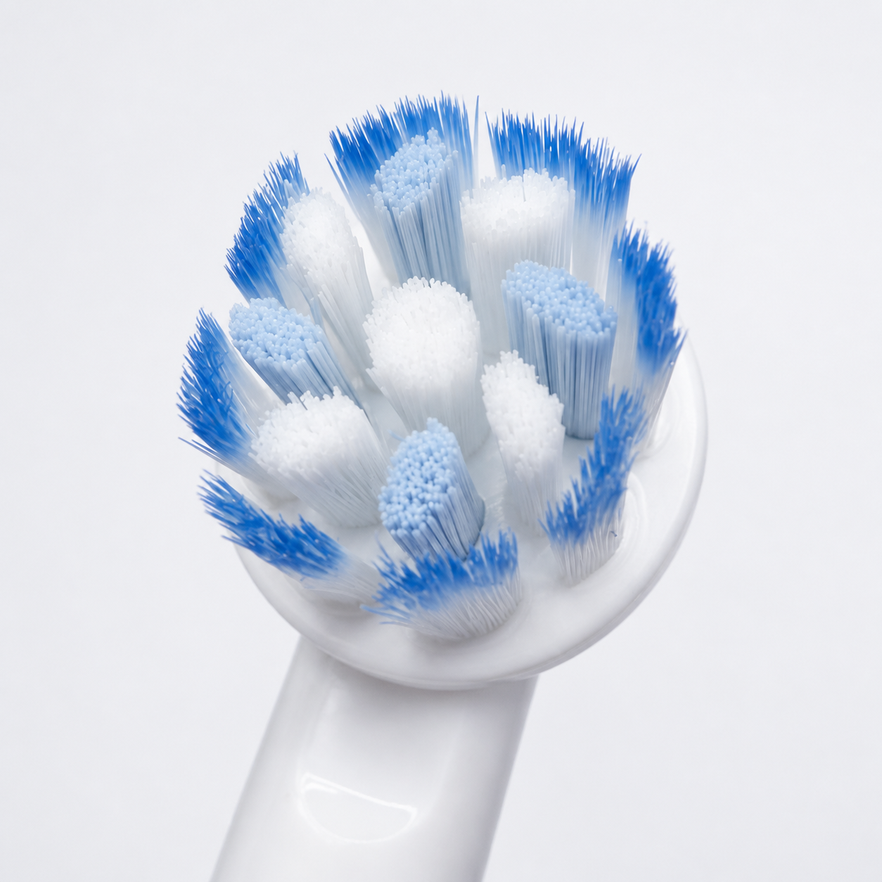 Close-up of Oral-B PRO Sensitive Clean X-shaped blue and white bristles